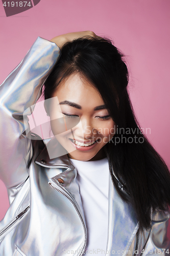 Image of young pretty smiling asian korean girl wearing modern fashion clothers on pink background, lifestyle people concept