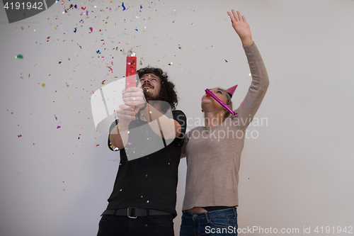 Image of romantic young  couple celebrating  party with confetti