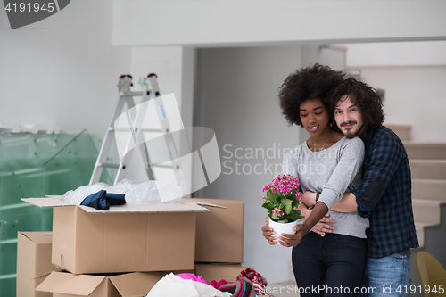 Image of multiethnic couple moving into a new home