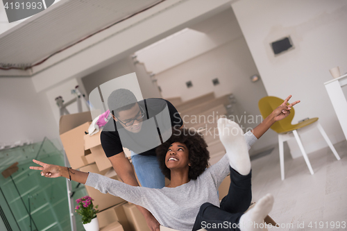 Image of African American couple  playing with packing material