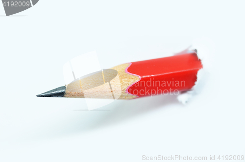 Image of Red pencil and white torn paper