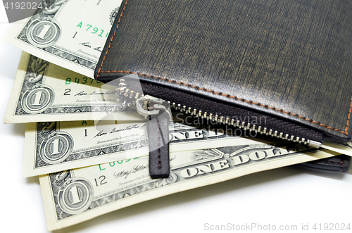 Image of Money sticking out of a leather wallet