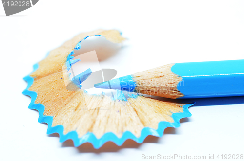 Image of Sharpened blue color pencil and wood shavings 