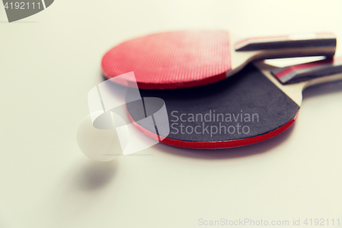 Image of close up of table tennis rackets with ball