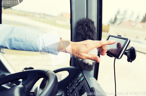 Image of close up of bus driver driving with gps navigator