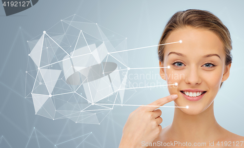 Image of smiling young woman face and shoulders