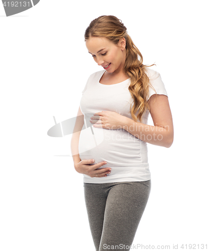 Image of happy pregnant woman touching her big belly