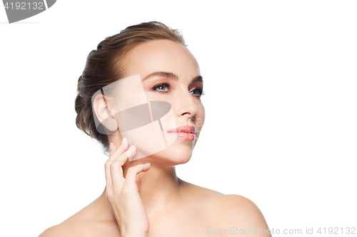 Image of beautiful young woman touching her face