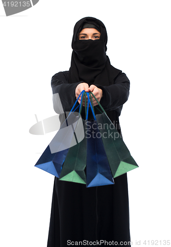 Image of muslim woman in hijab with shopping bags