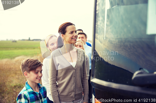 Image of group of happy passengers boarding travel bus