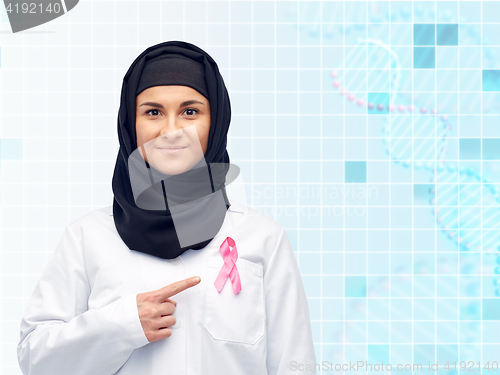 Image of muslim doctor with breast cancer awareness ribbon