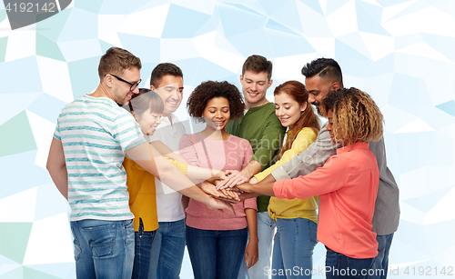 Image of international group of happy people holding hands