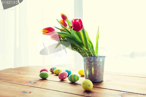 Image of close up of easter eggs and flowers in bucket