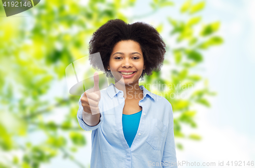 Image of happy afro american woman showing thumbs up