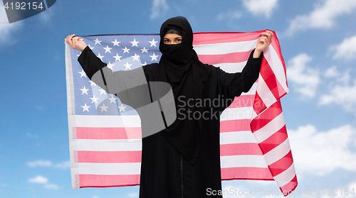 Image of muslim woman in hijab with american flag