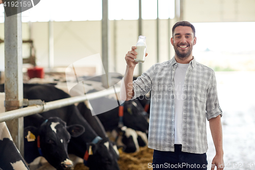 Image of man or farmer with cows milk on dairy farm