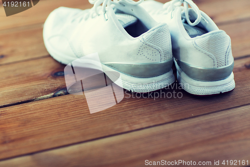 Image of close up of sneakers on wooden floor