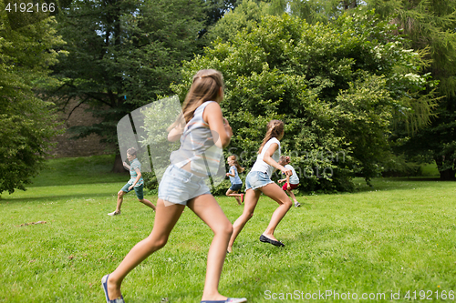 Image of group of happy kids or friends playing outdoors