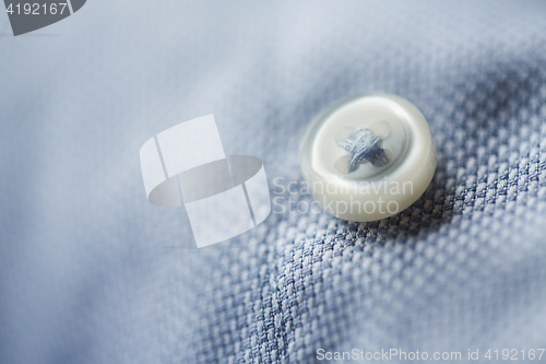 Image of close up of blue shirt button