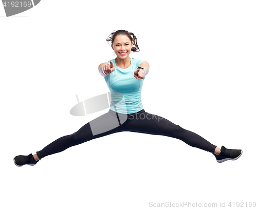 Image of happy smiling sporty young woman jumping in air