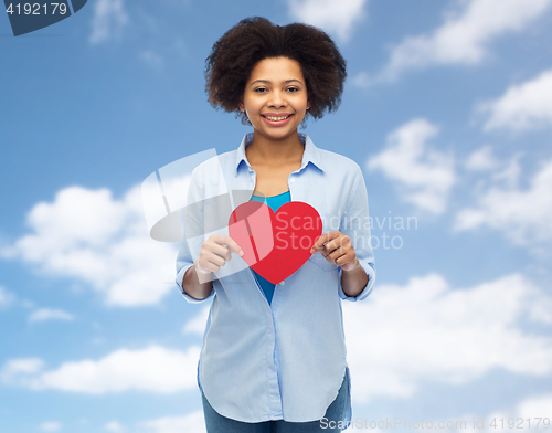 Image of happy african american woman with red heart shape