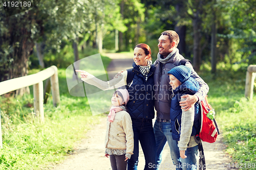 Image of happy family with backpacks hiking