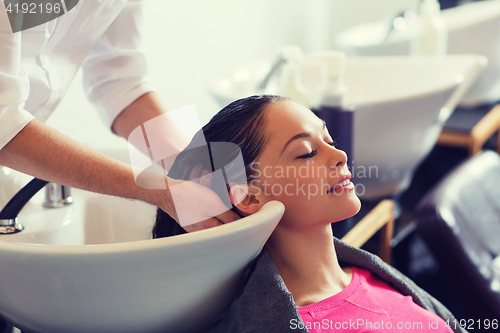 Image of happy young woman at hair salon