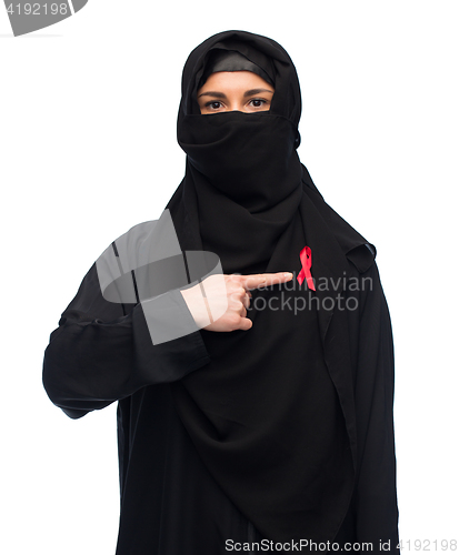 Image of muslim woman in hijab with red awareness ribbon