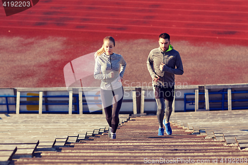 Image of couple running upstairs on stadium