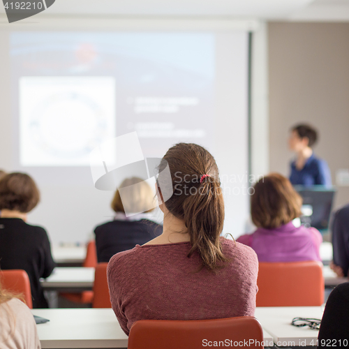 Image of Woman giving presentation in lecture hall at university.