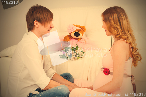 Image of Man and pregnant woman sitting face to face