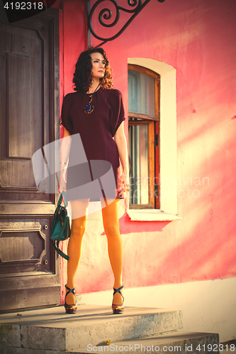 Image of beautiful woman on the porch of an old building