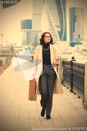 Image of Beautiful middle-aged woman in a bright coat