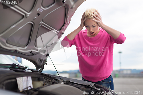 Image of Stressed Young Woman with Car Defect.