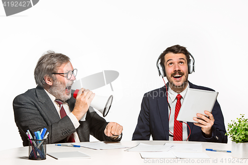 Image of The two colleagues working together at office on white background.