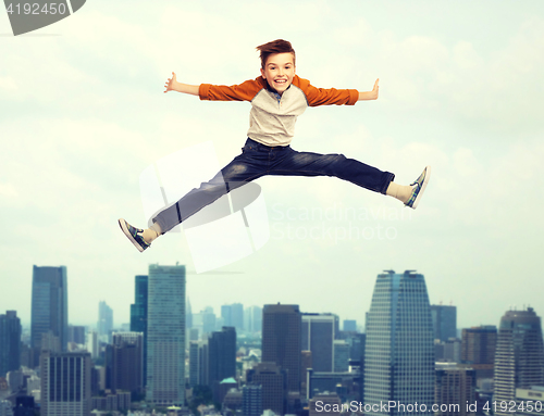 Image of happy smiling boy jumping in air