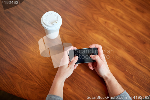 Image of close up of woman with smartphone and coffee