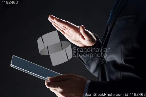 Image of close up of businessman with transparent tablet pc