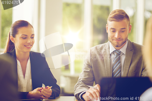 Image of smiling business people meeting in office