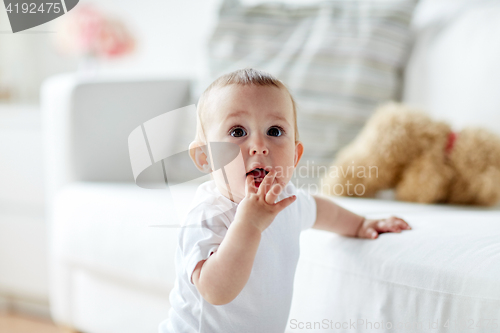 Image of happy little baby boy or girl at home