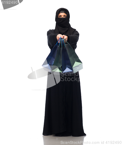 Image of muslim woman in hijab with shopping bags