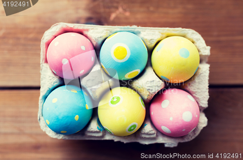 Image of close up of colored easter eggs in egg box