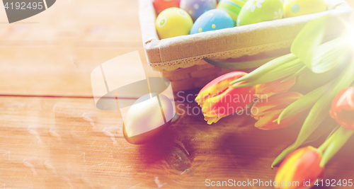 Image of close up of colored easter eggs and flowers