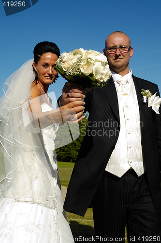 Image of Wedding couple holding bouquet