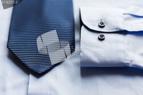 Image of close up of shirt and blue patterned tie