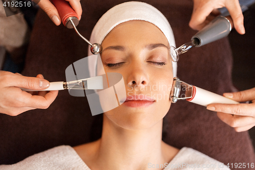 Image of woman having hydradermie facial treatment in spa