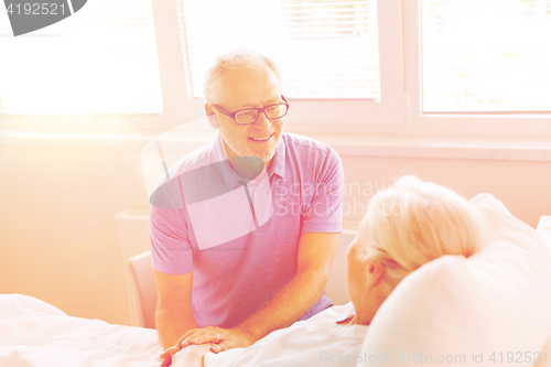 Image of senior couple meeting at hospital ward