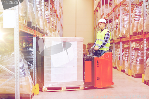 Image of man on forklift loading boxes at warehouse