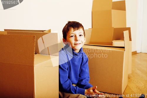 Image of little cute boy in empty room, remoove to new house. home alone, lifestyle people concept