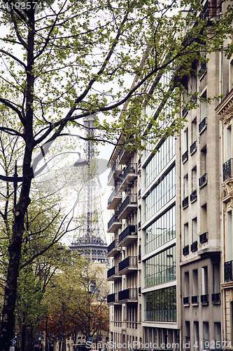 Image of french paris street with Eiffel Tower in perspective trought trees, post card view